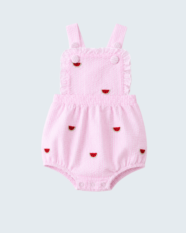 Pink baby romper with red heart designs on a light gray background