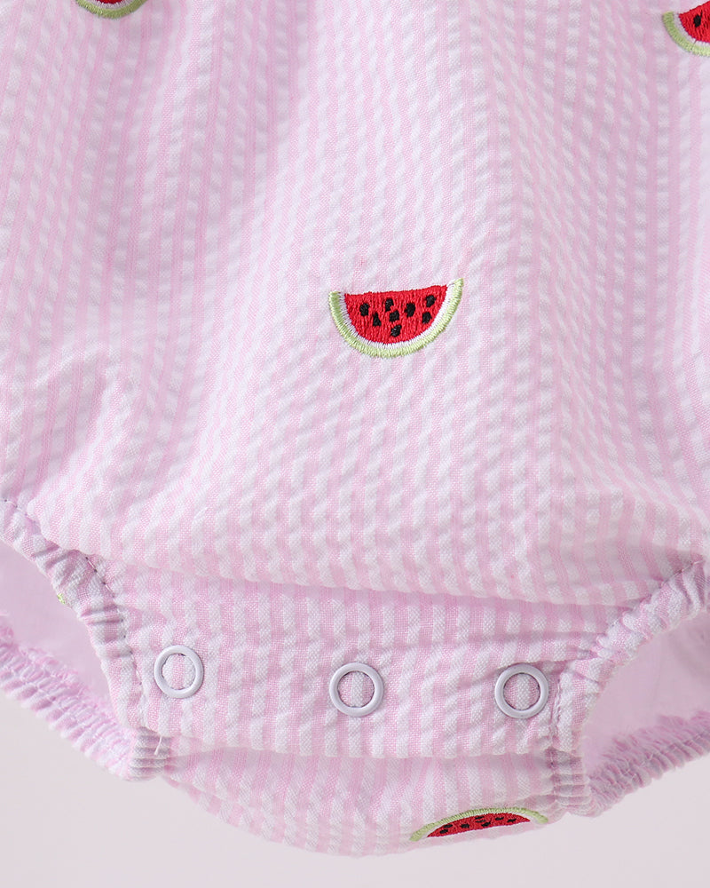 Pink baby romper with watermelon designs on a white background
