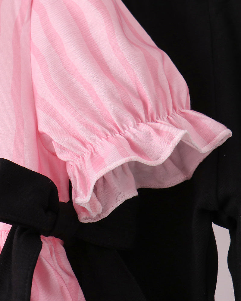 Pink striped ruffle sleeve top with black leggings waistband and bow trim