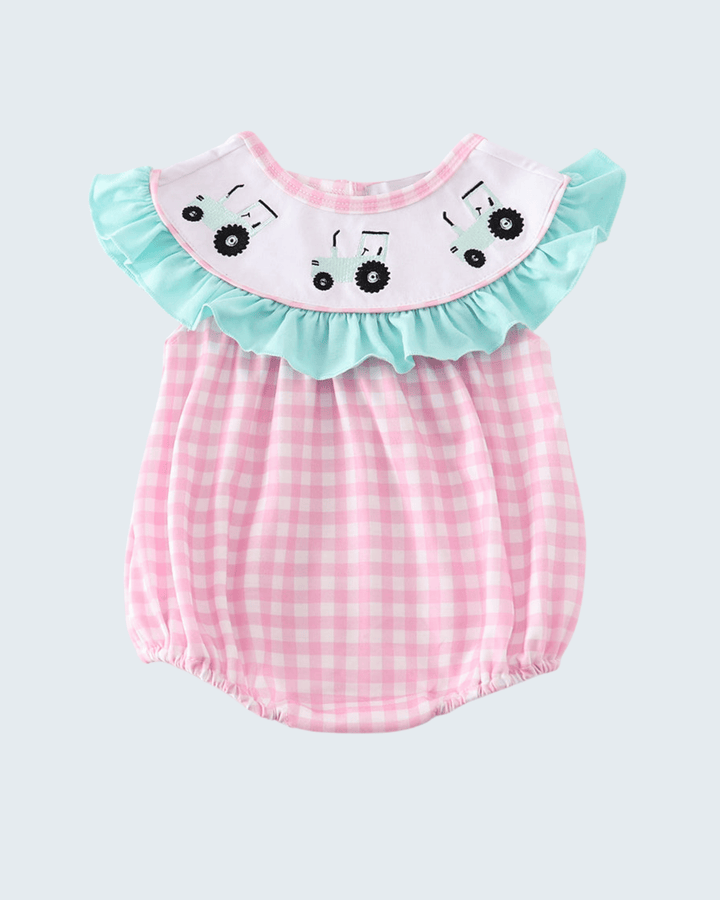 Baby romper with pink checkered pattern and turquoise ruffled collar on a light gray background