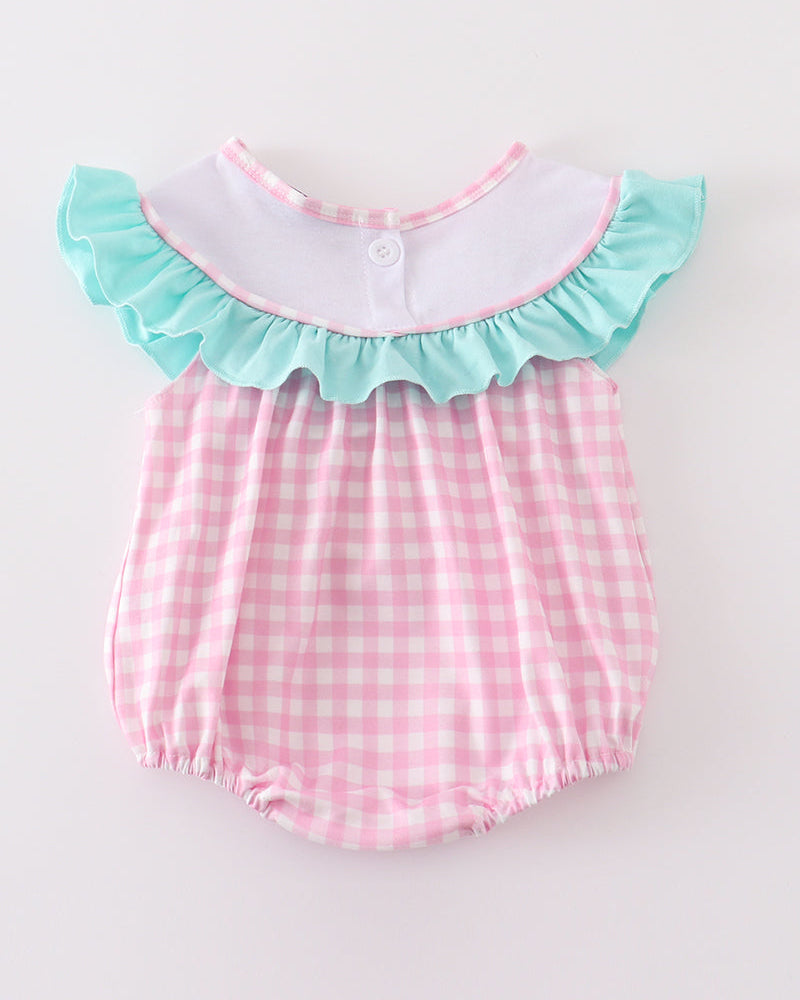 Pink checkered baby romper with teal trim on a white background