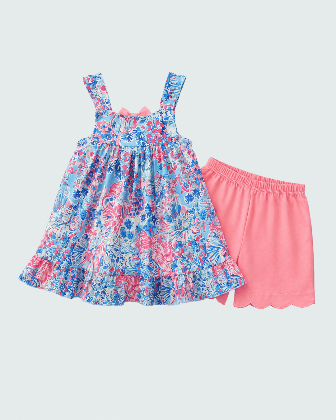 Floral dress and pink shorts set on a light gray background