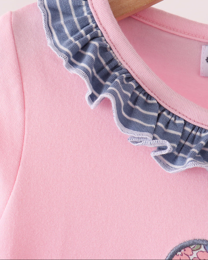 Pink bodice with blue striped scalloped ruffle trim at neck and sleeves