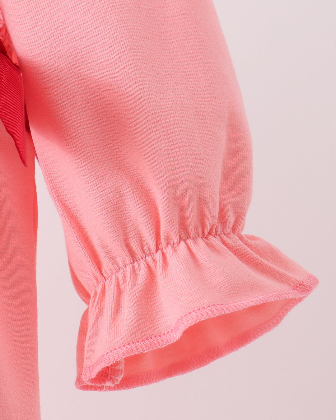 Pink bubble romper sleeve with gathered cuff and ruffled hem