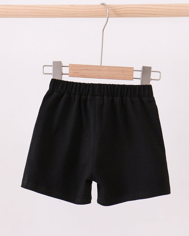 Black shorts with elastic waistband and loose, above-knee cut.