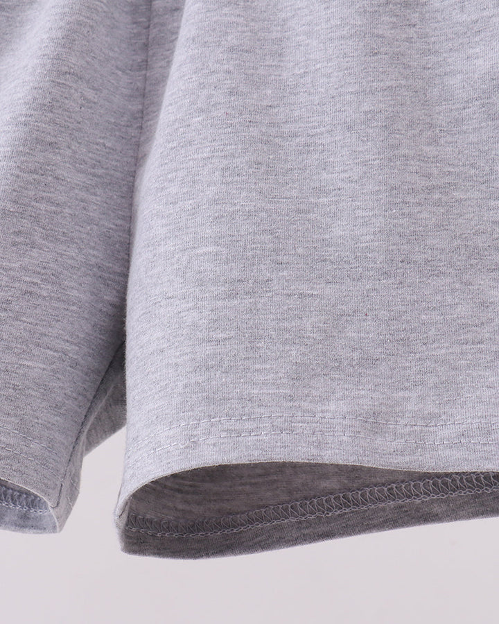 Light grey shorts showing cuffs and dark inner hem stitching