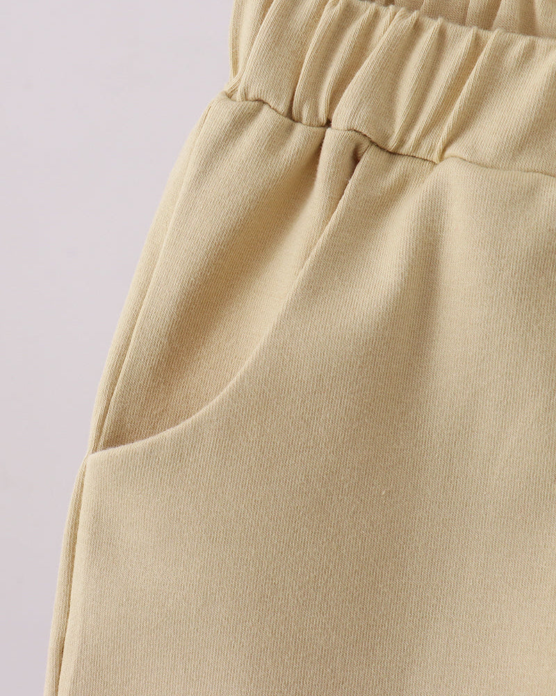 Light khaki shorts with elastic waistband and side seam detail