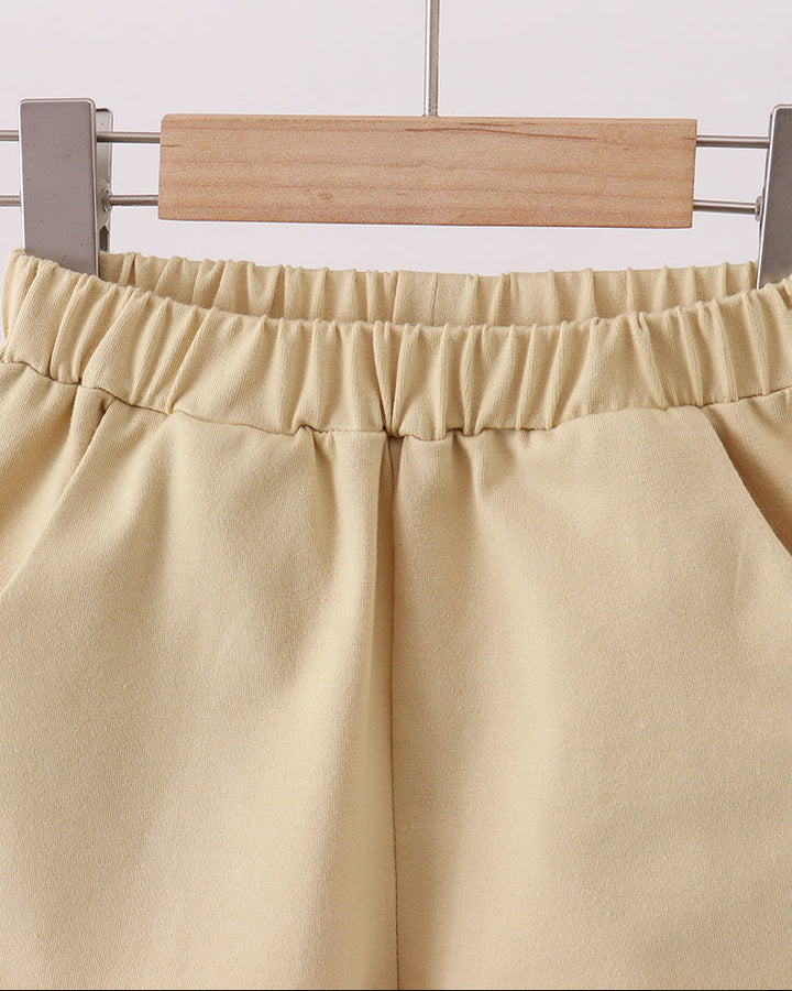 Light khaki shorts with elastic waistband and front seam pleats