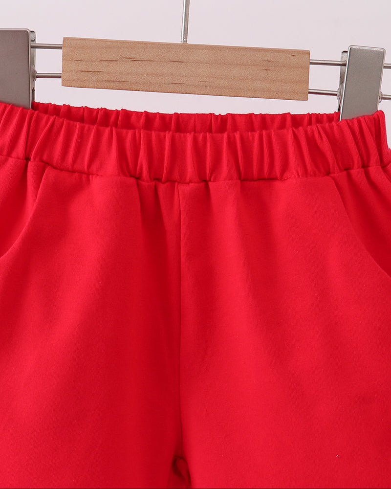 Red elastic-waist shorts with gathered waistband, side view