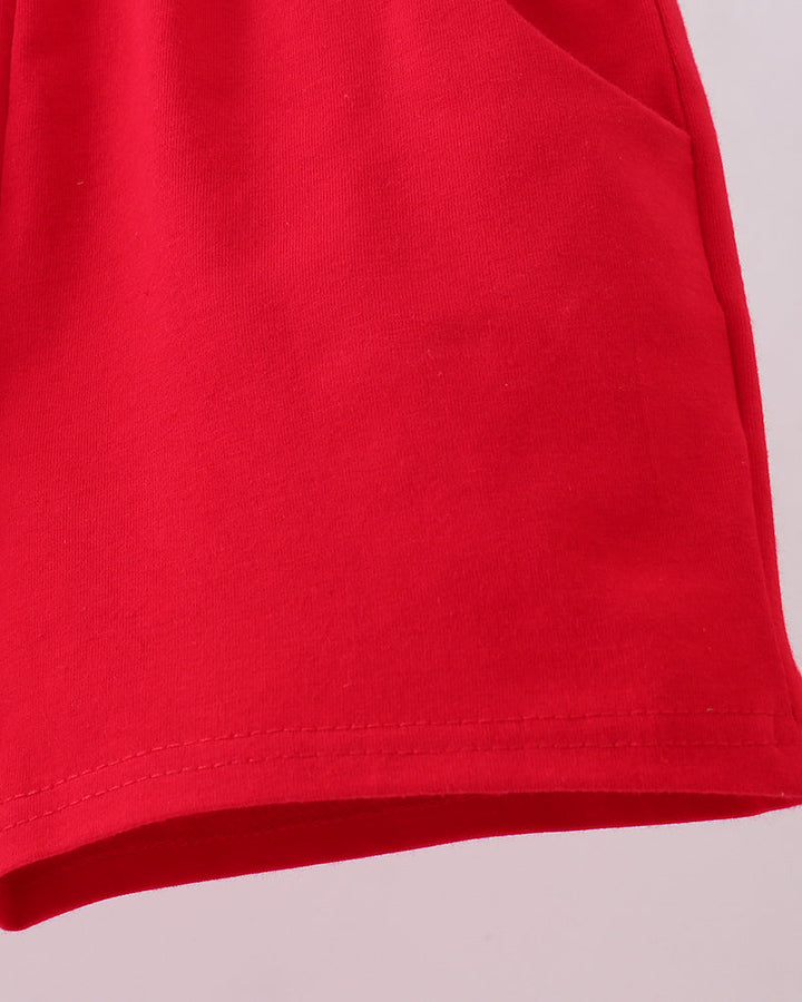 Red shorts hem with curved seam and stitched edge