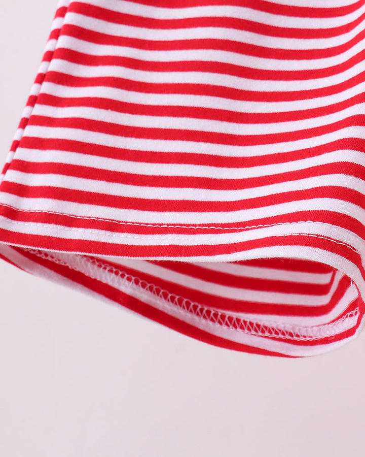 Folded hem of red and white striped shorts with visible stitched edging