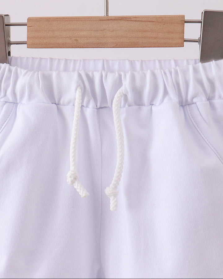 White drawstring shorts with elastic waist and gathered waistband, front view