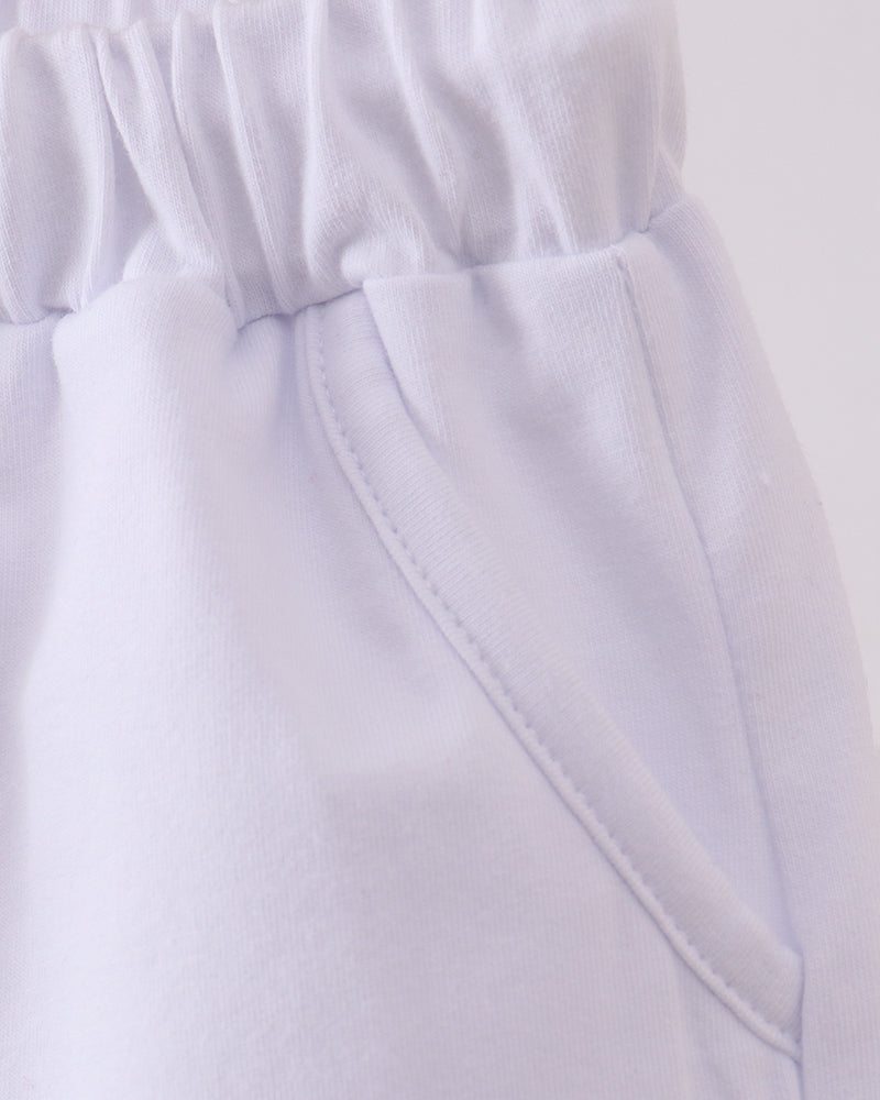 White shorts with elastic waistband and angled front pocket seam detail