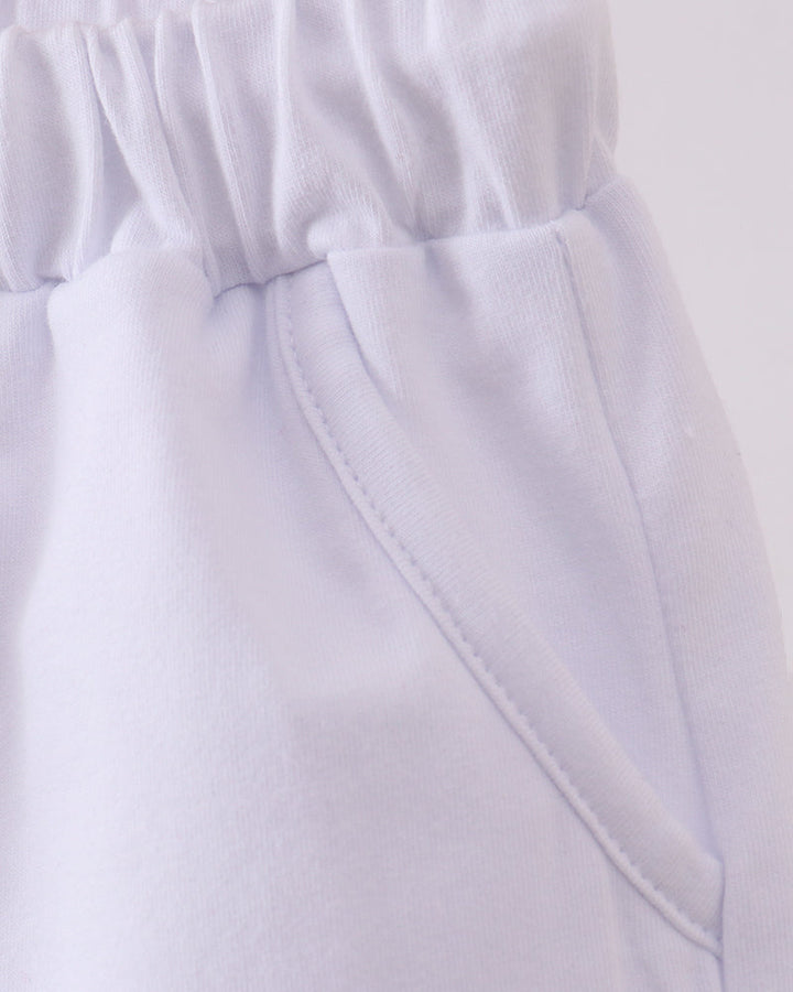 White shorts with elastic waistband and angled front pocket seam detail