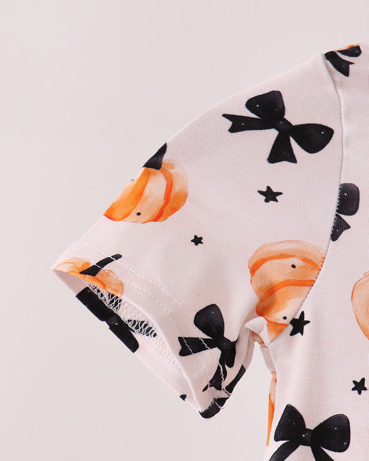 White romper sleeve with orange pumpkin faces and black bow pattern