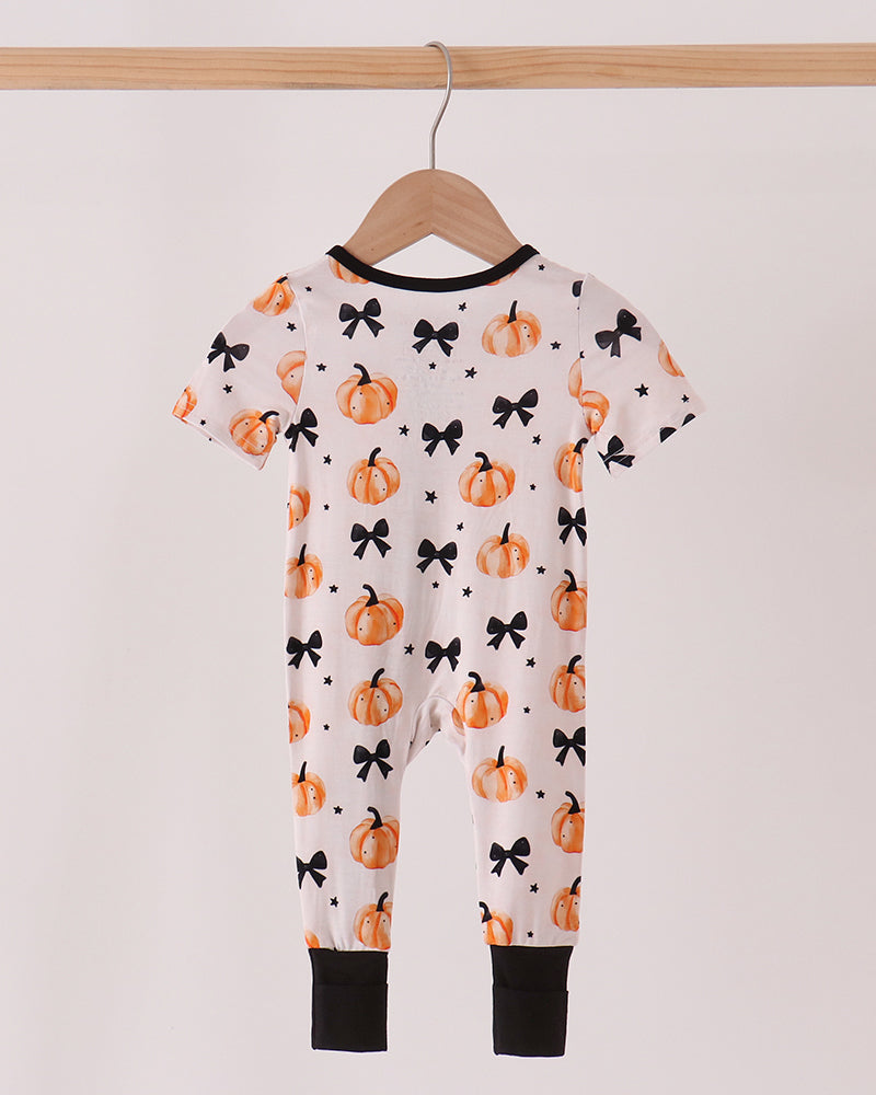 Bamboo baby one-piece romper with pumpkin-and-bow print, black cuffs and short sleeves