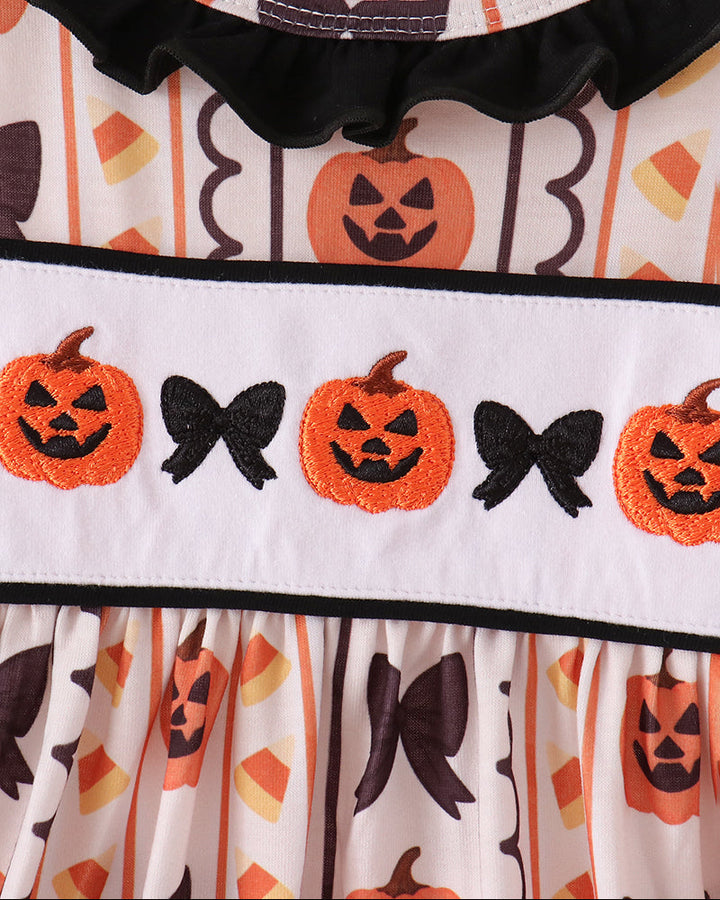 Embroidered ruffle dress yoke with orange pumpkins and black bats, bow trim at neck