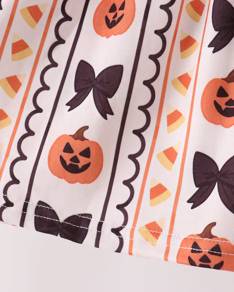 Orange pumpkin and black bat pattern ruffle top fabric with scalloped trim and stitched edges