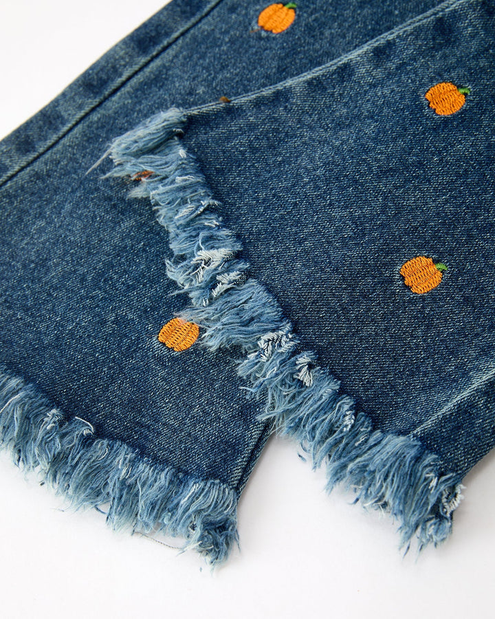 Denim flare jeans with distressed knee and orange pumpkin embroidery