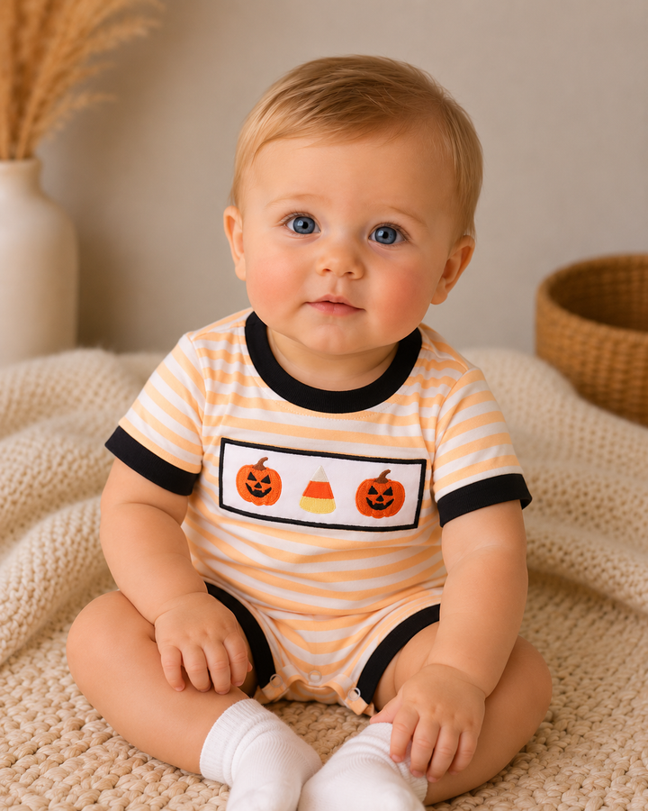 Orange-and-white striped romper with black trim and pumpkin graphic front