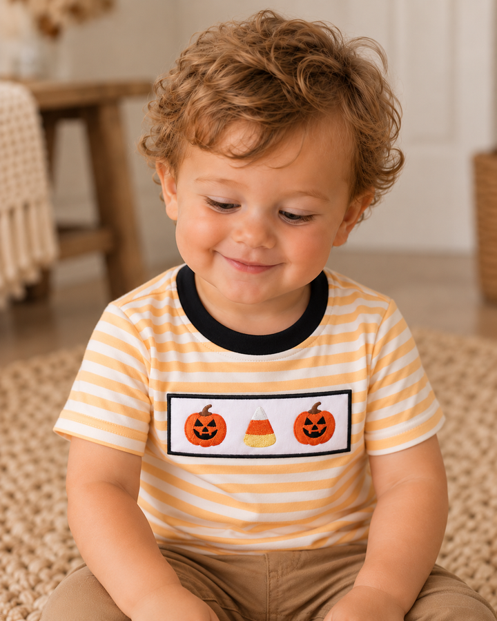 Orange-and-white striped top with black neckline and embroidered pumpkins on chest