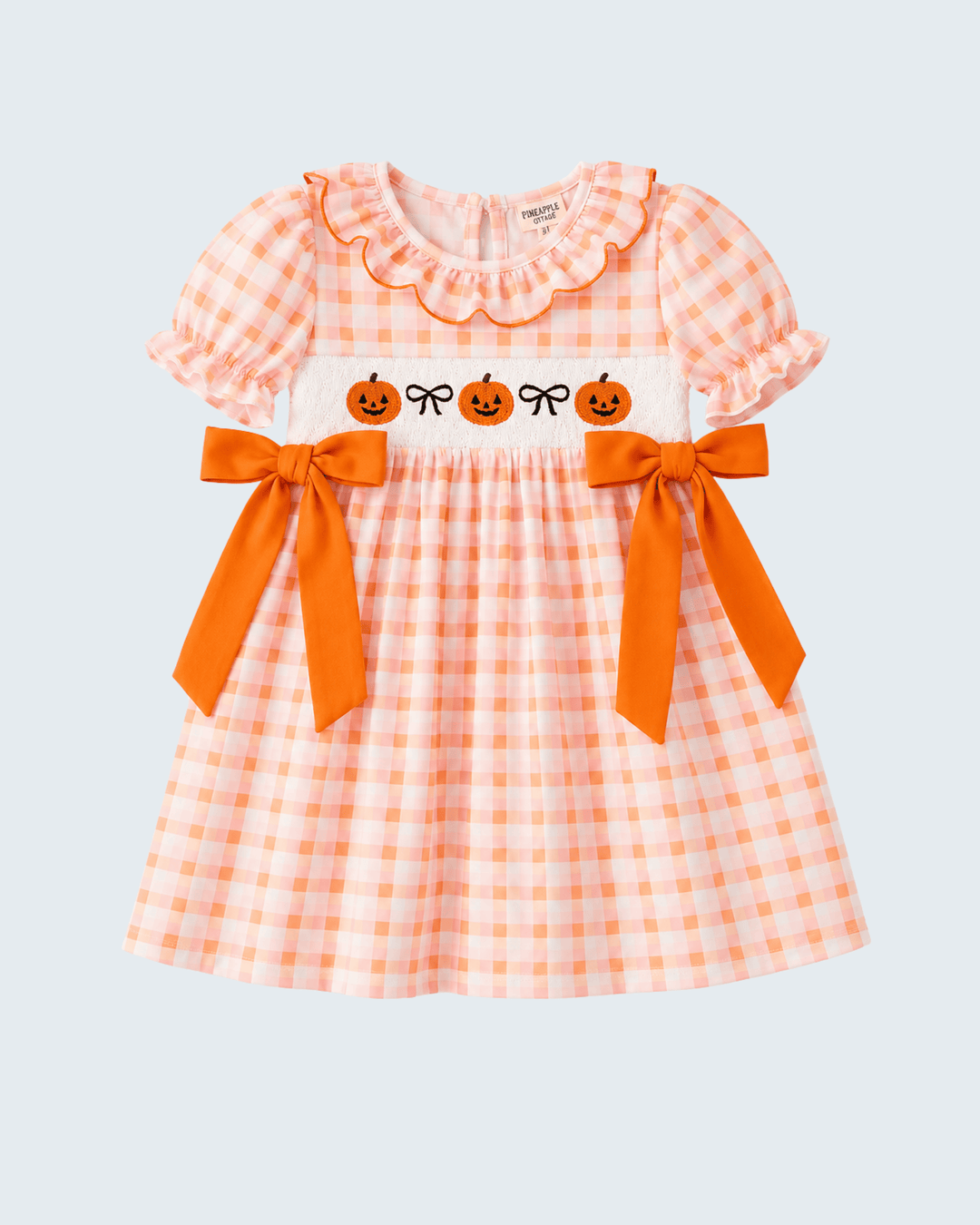 Orange and white plaid bow dress with ruffled neckline, pumpkin print, and waist bows