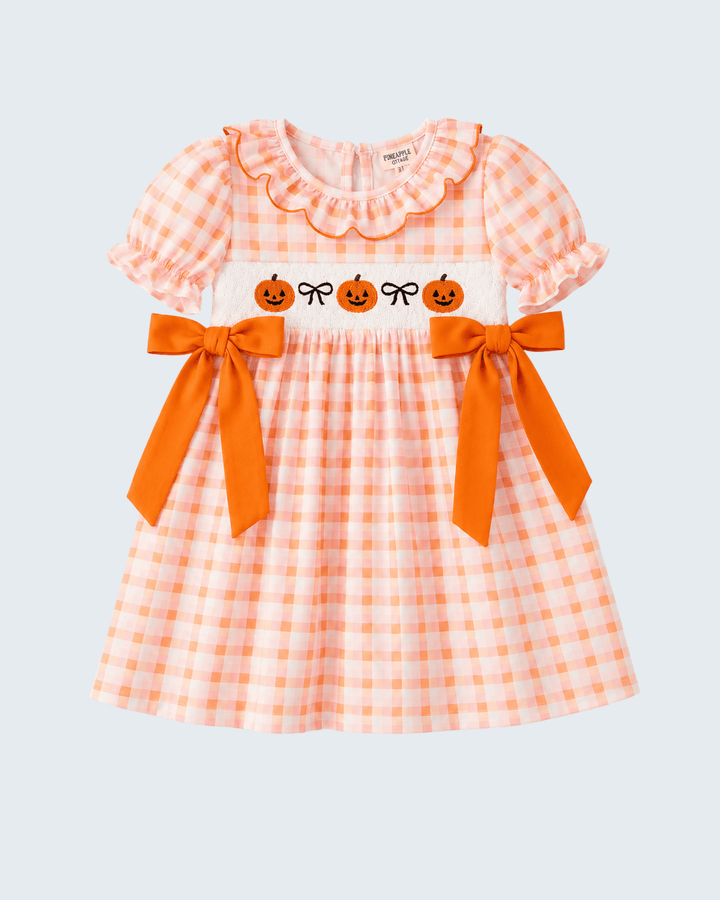 Orange and white plaid bow dress with ruffled neckline, pumpkin print, and waist bows