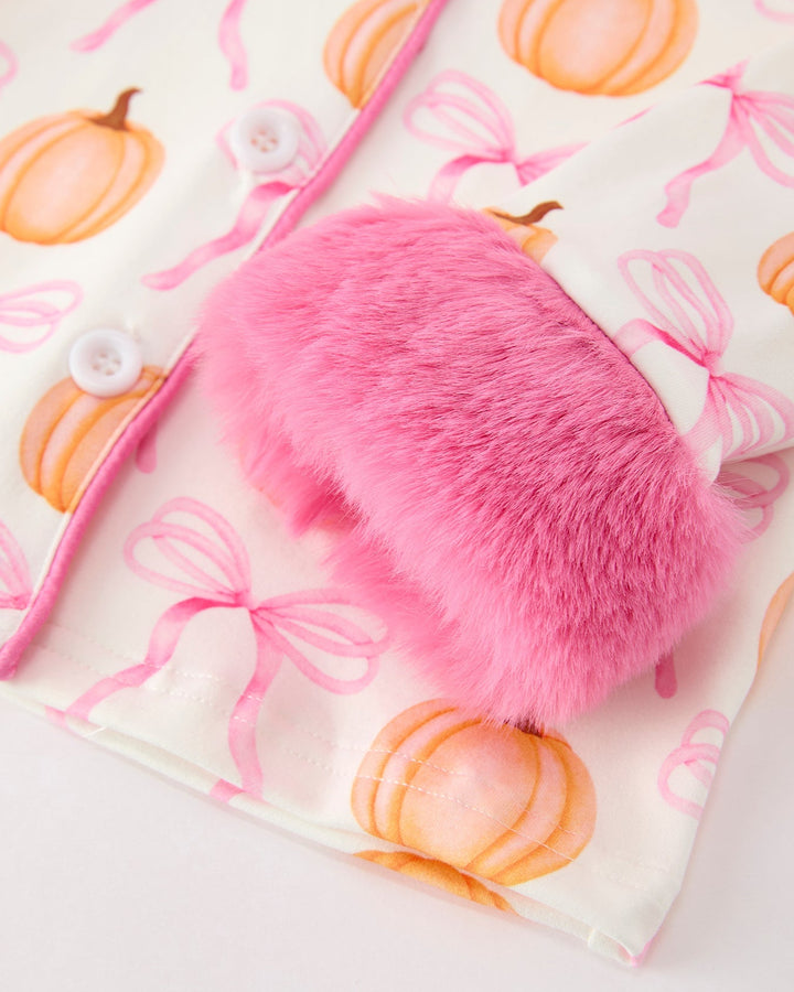 Pink faux-fur front pocket detail on pumpkin-and-bow pajama top