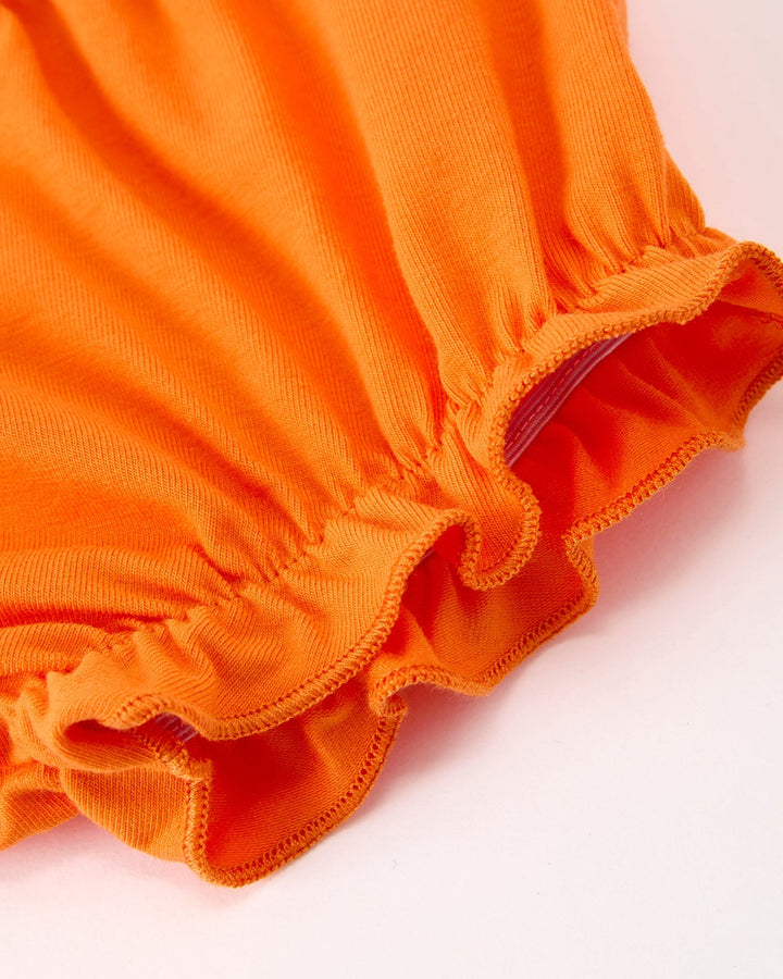 Orange bloomer shorts with gathered ruffle leg cuffs and elastic waist