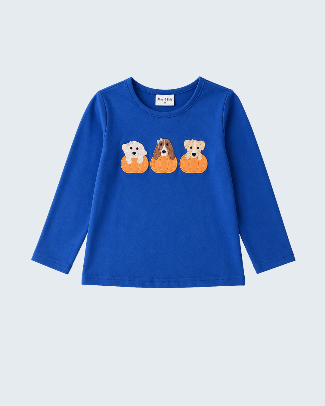 Blue long-sleeve top with embroidered pumpkin dogs across the chest