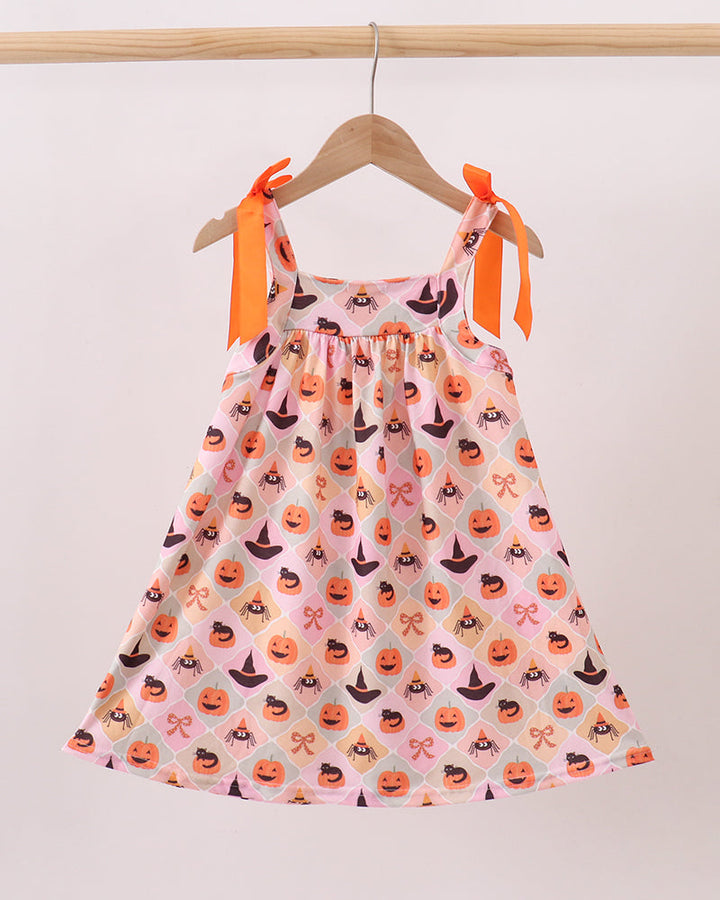 Sleeveless Halloween dress with orange bow straps and pumpkin spider pattern on pink