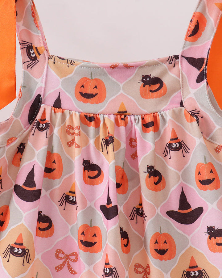 Close-up of sleeveless dress bodice with orange bow straps and Halloween icons