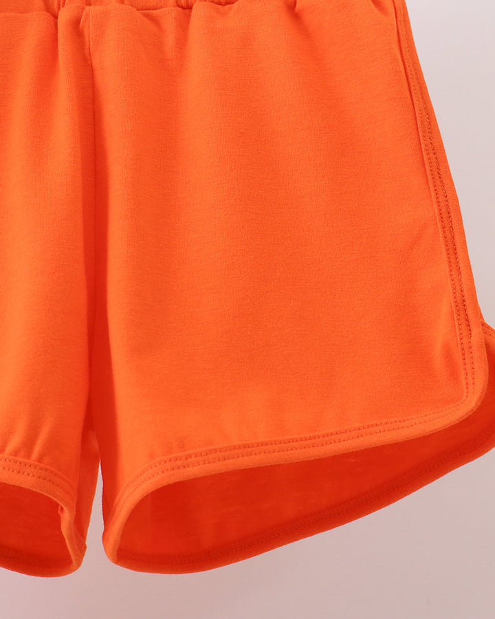 Bright orange knit shorts with elastic waistband and stitched hem