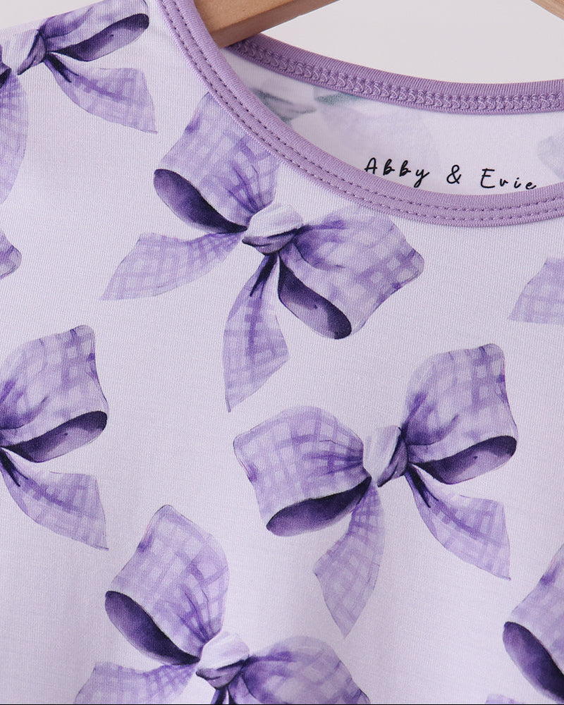 Purple bow-print bamboo pajama top neckline with small chest logo