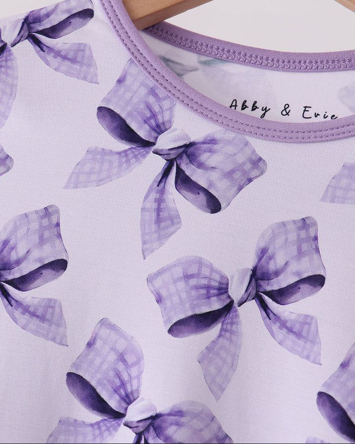 Purple bow-print bamboo pajama top neckline with small chest logo