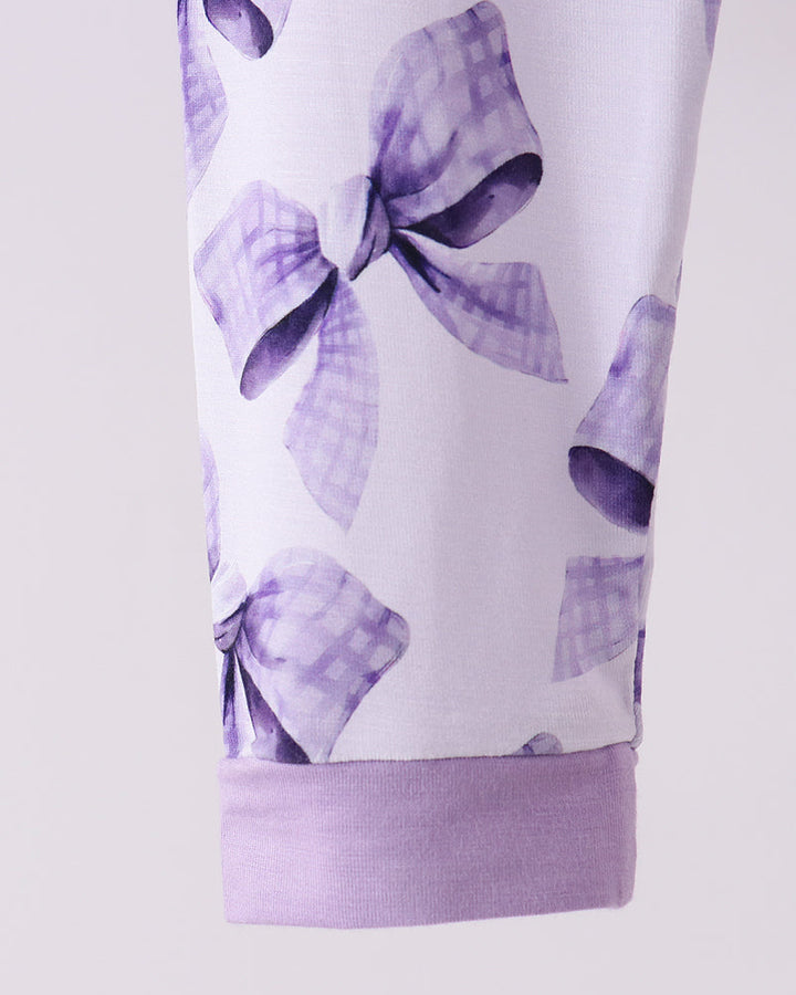 Purple bow-print bamboo pajama pants with elastic waistband and cuff