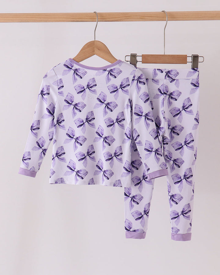Purple bow-print bamboo pajama set showing zip-front top and matching pants