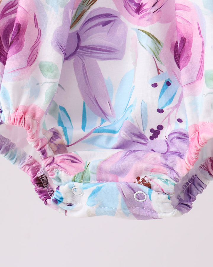 Purple floral romper with snap closure