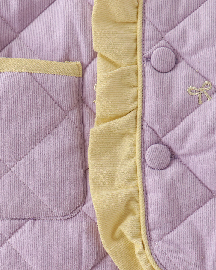 Lavender quilted jacket panel with yellow ruffle trim and small bow embroidery