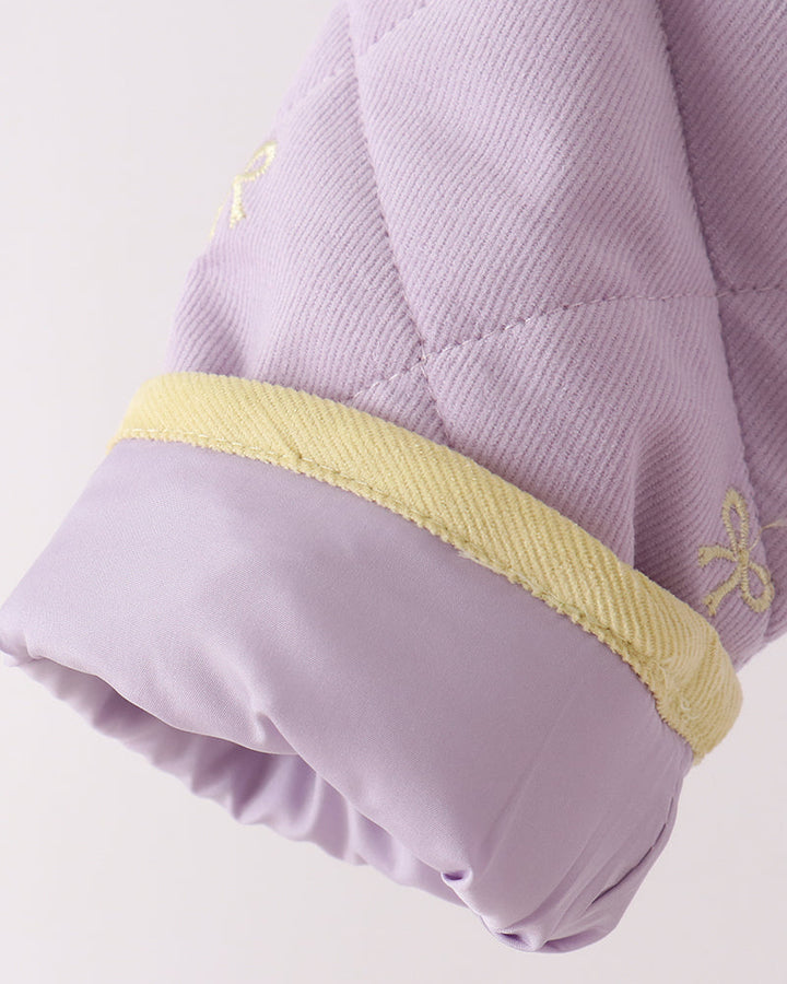 Lavender jacket sleeve cuff with yellow trim and gathered ruffle hem