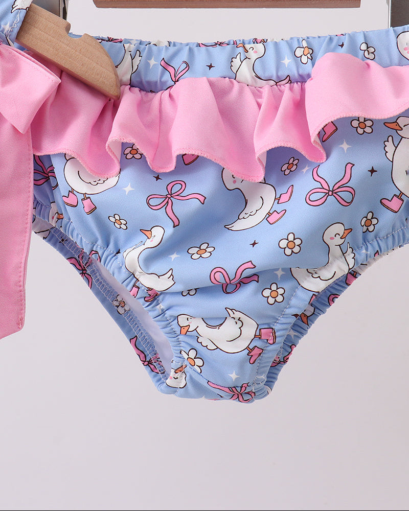 Children's swim bottoms with duck and bow pattern on a hanger