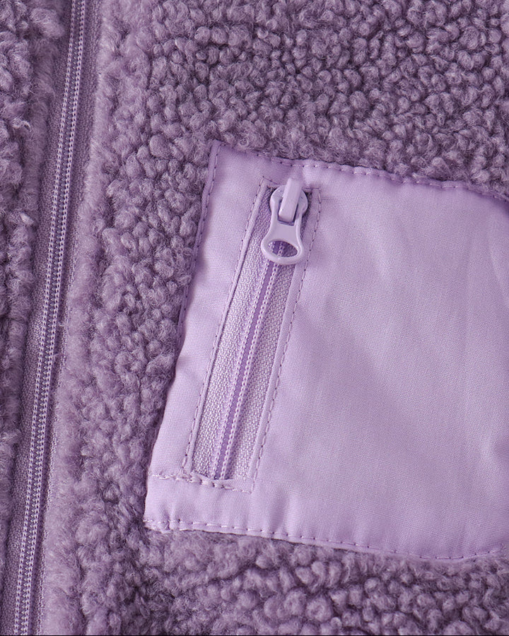 Purple fleece front pocket with visible zipper and light lining