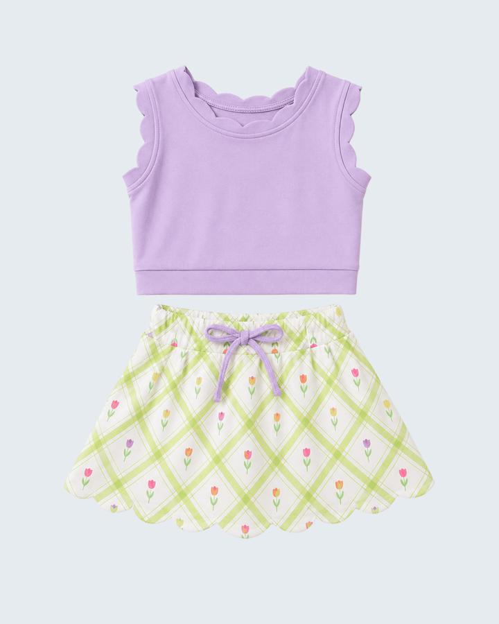 Purple tank top and checkered skirt set on a light purple background