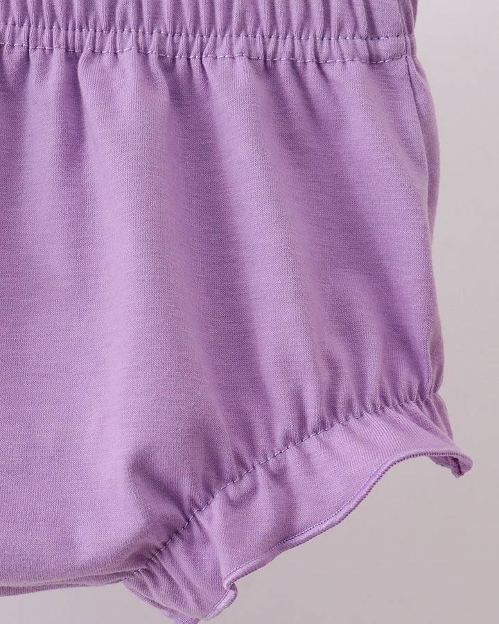 Purple baby bloomers on a light gray background