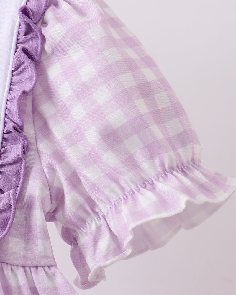 Purple and white checkered dress with ruffled sleeves on a light pink background