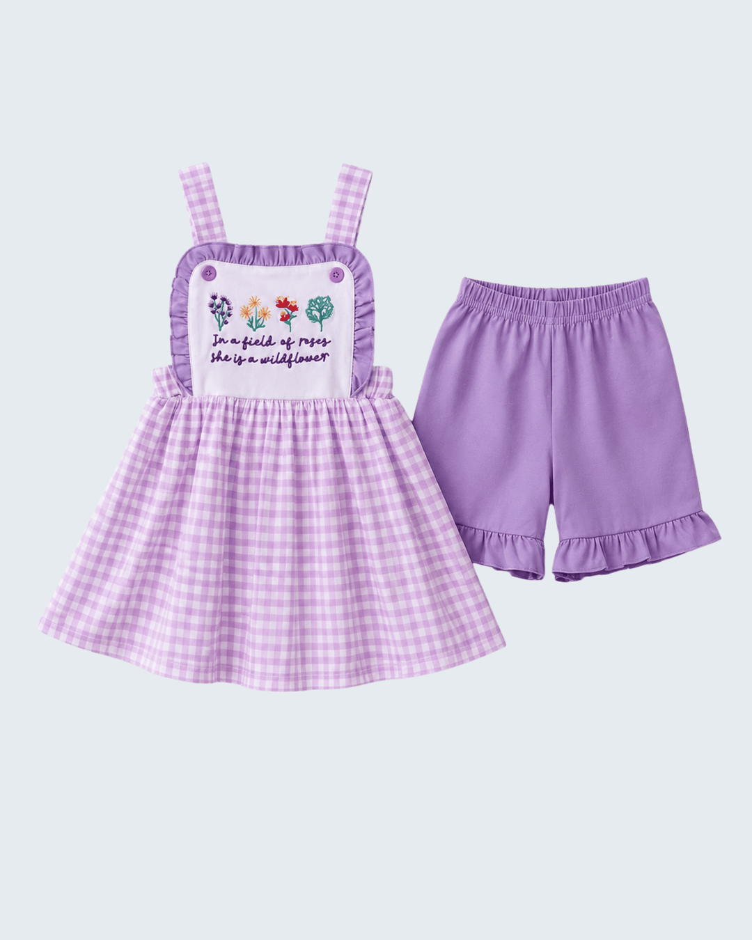 Purple checkered dress with ruffled straps and matching shorts on a light purple background