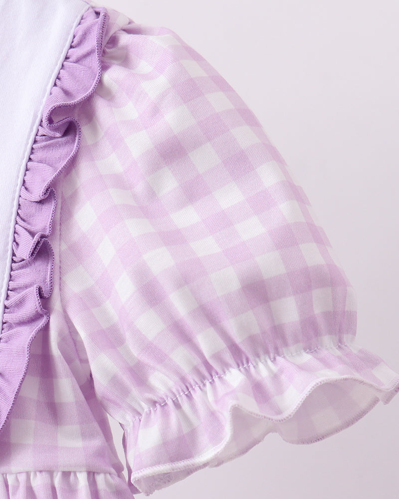 Purple and white checkered dress with ruffled sleeves on a light gray background