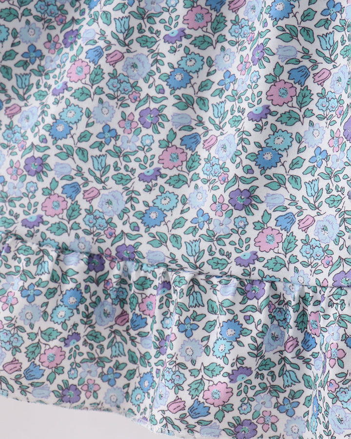 Floral patterned fabric with blue, pink, and green colors on a white background