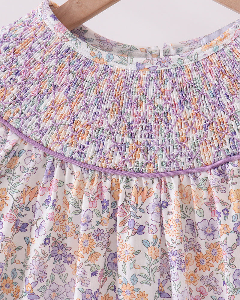 Floral dress with smocked neckline on a white background