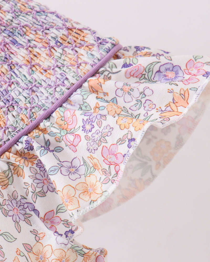 Floral-patterned fabric with a purple border on a light background
